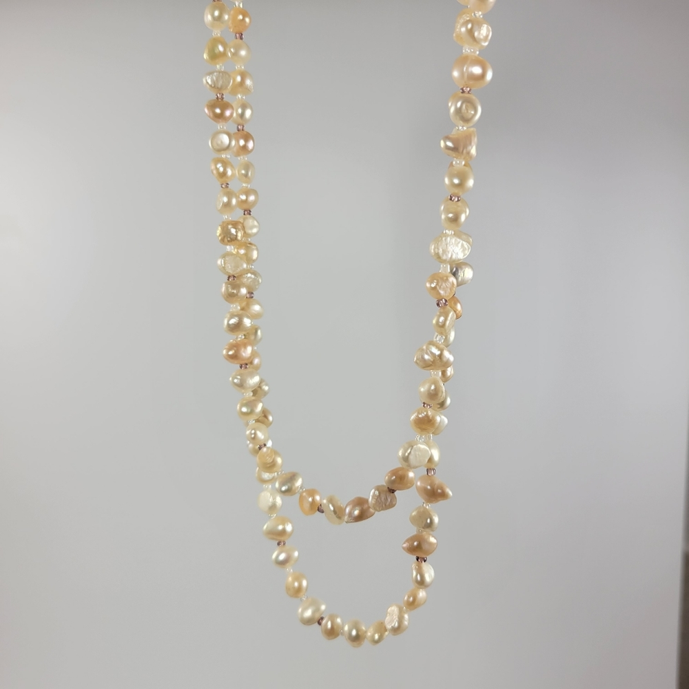 New. Fresh water pearls. Pink cream color. 18" /9" long.